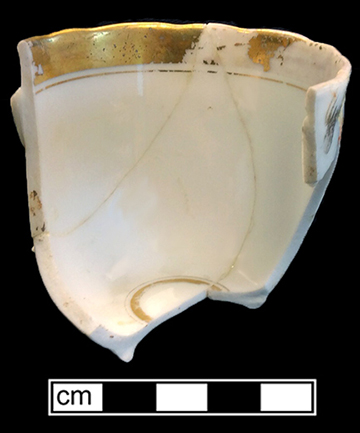 European hard paste porcelain, painted cup with molded leaf rim with gold gilt trim, gold gilt rim on interior, painted overglaze floral sprigs in pink, orange, blue, purple & yellow.